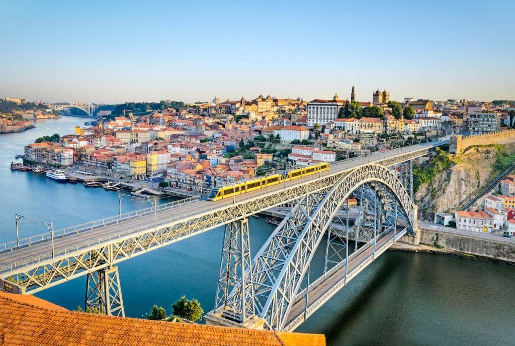 Gray bridge near buildings during daytime in Porto, one of the best things to see in Portugal