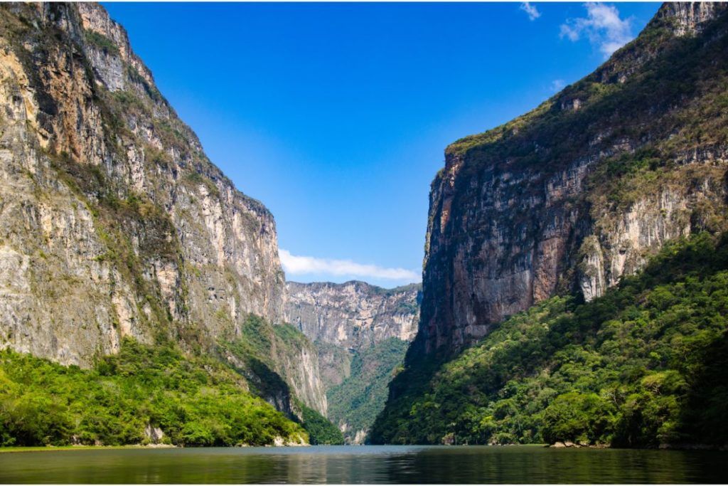 green and brown mountains beside water in sumidero canyon