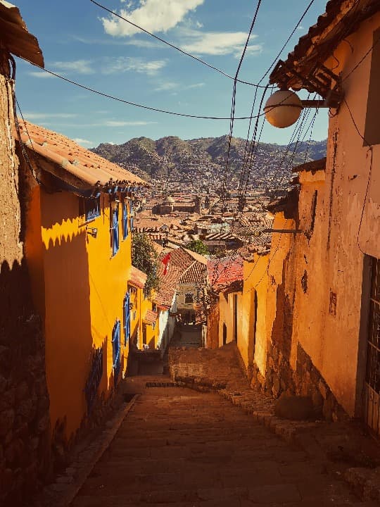 Orange houses and green mountain in Cusco