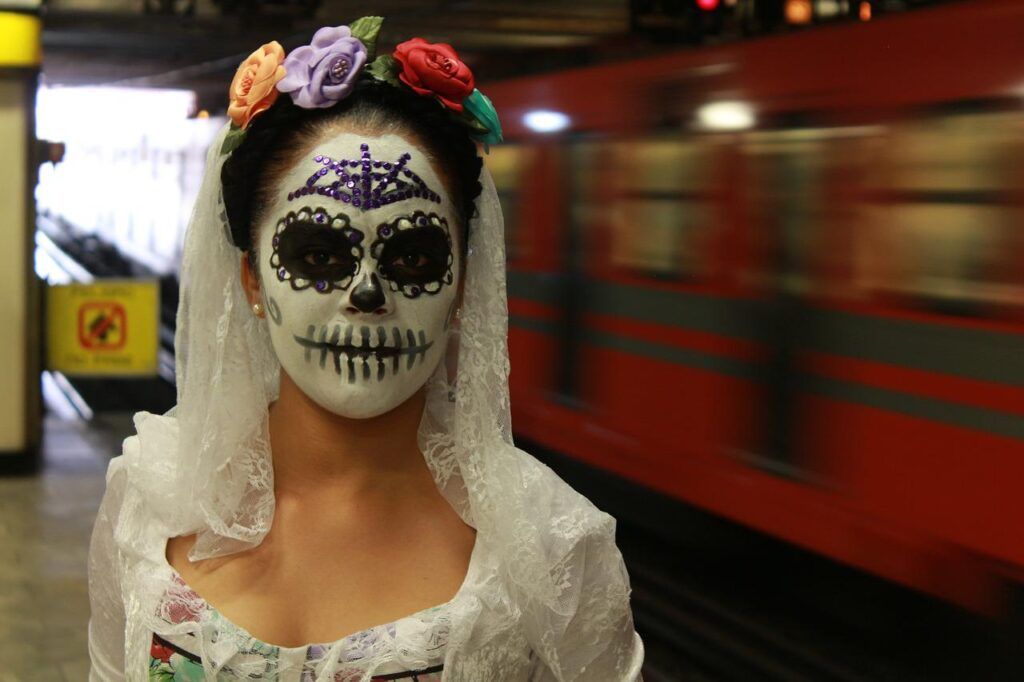 girl dressed for dia de los muertos in Mexico City underground station