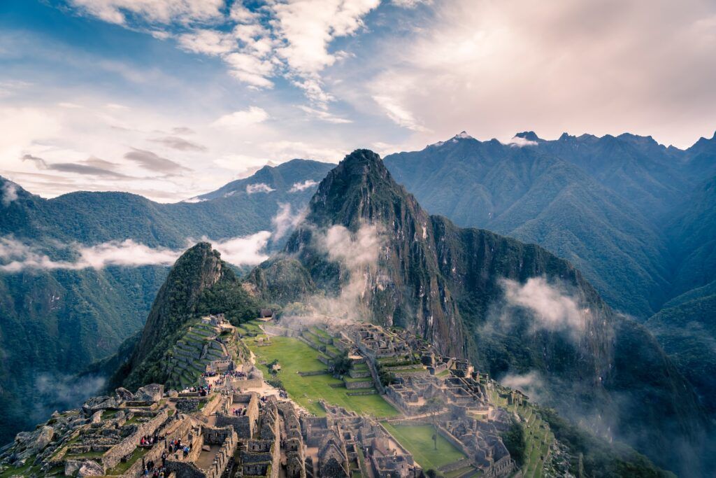 Aerial photo of mountains and Machu Picchu ruins on a cloudy day