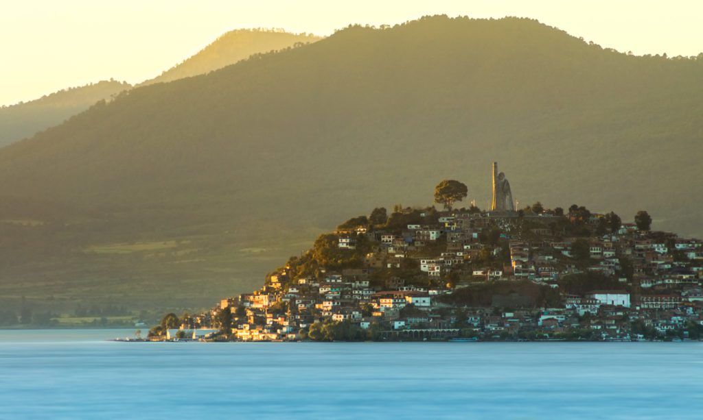 Patzcuaro lake and island of Janitzio with its buildings at sunset