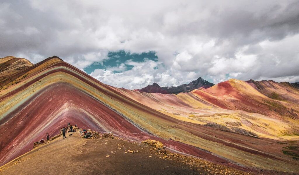 Rainbow mountains under grey clouds