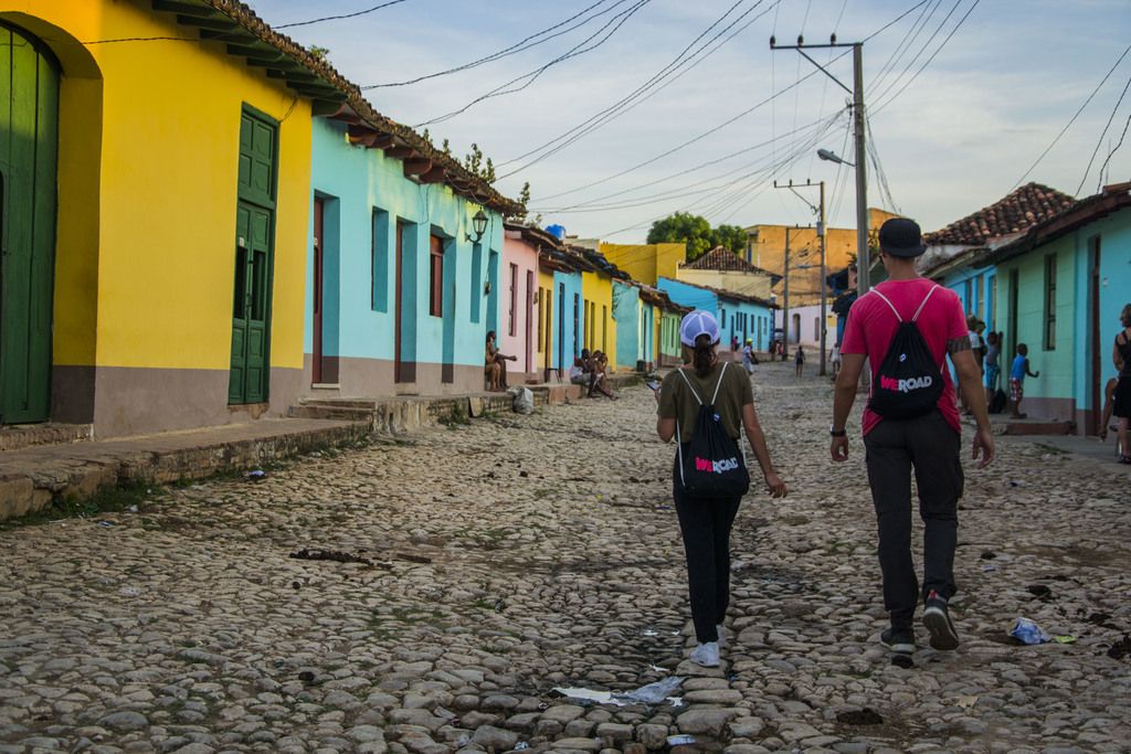 Guys walking through the picturesque Trinidad's street