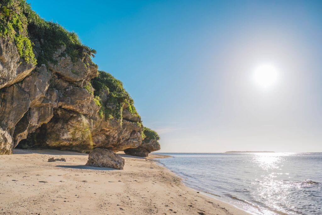 brown and green rocks on the seashore in Okinawa