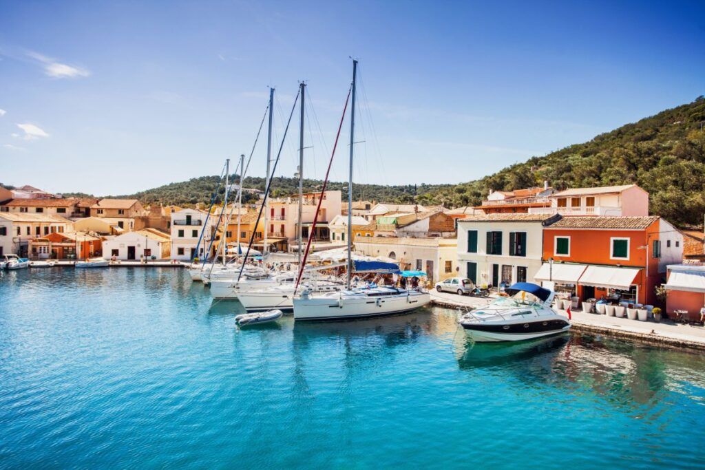 boats and colorful houses in Paxos in the daytime