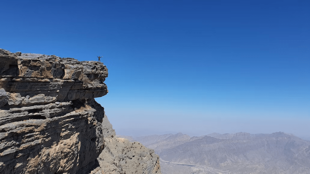 A person on top of Jebel Shams, the mountain of the sun