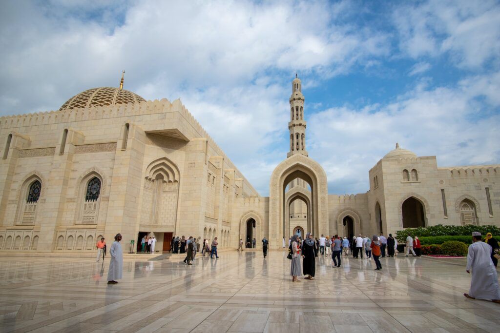 People walk in front of the mosque of Sultan Qaabos