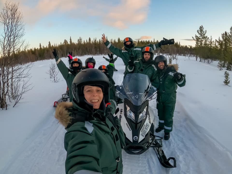 People around a snowmobile in Lapland
