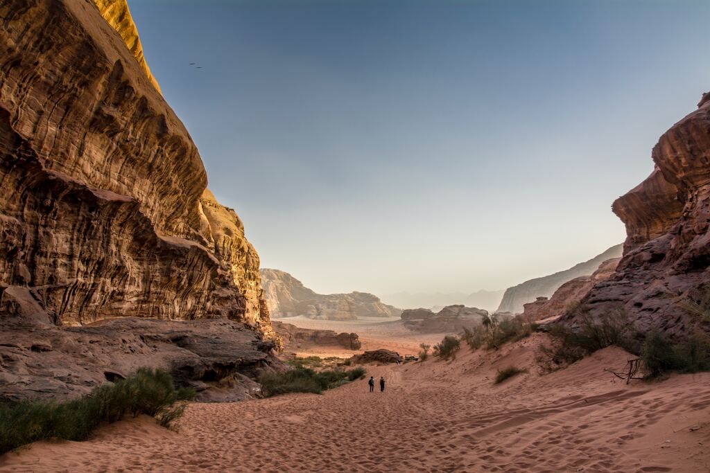 Brown rocky mountain under blue skies during the day in Jordan.