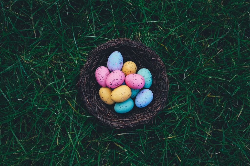 A basket filled with coloured eggs for Easter.