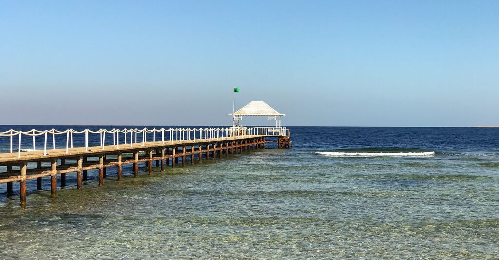 A long pier extends into the ocean.