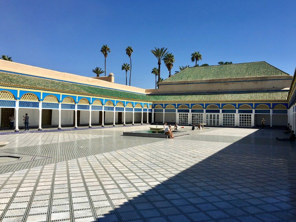 A courtyard with Bahia Palace in the background in Marrakesh
