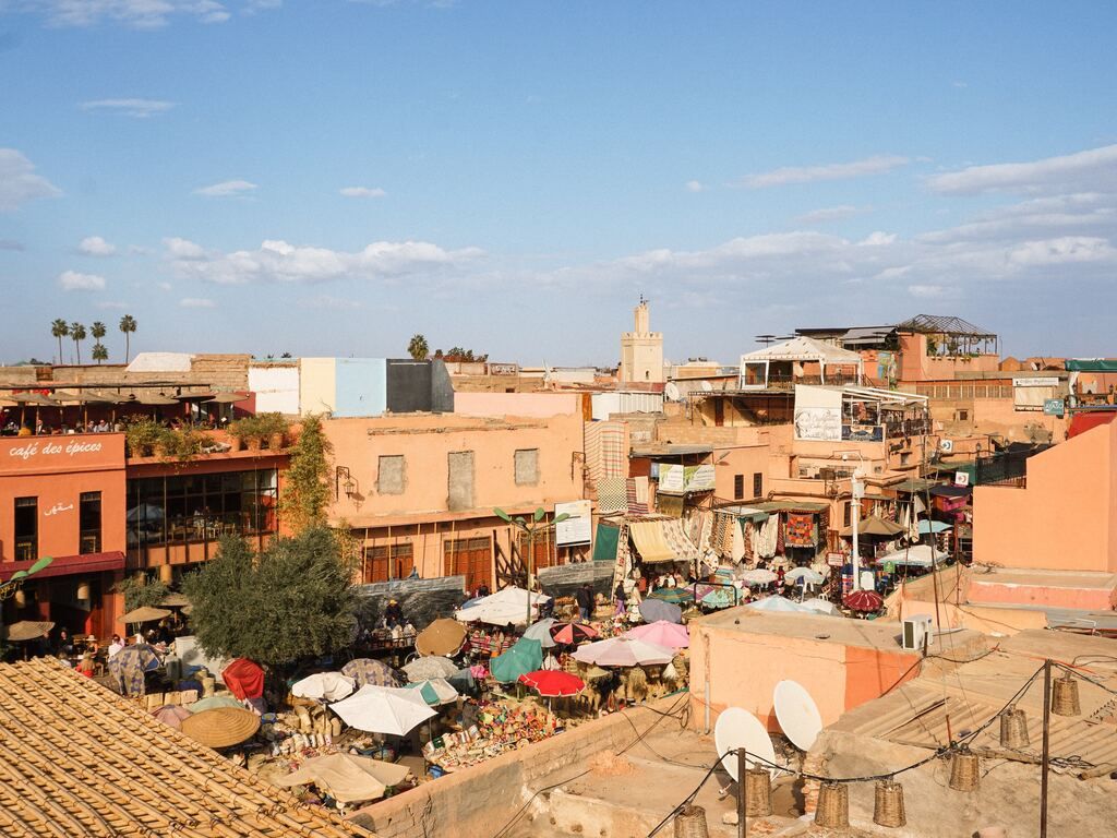 A view of the city with many buildings and parasols.