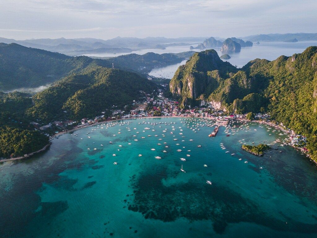 landscape photography of island with boats.