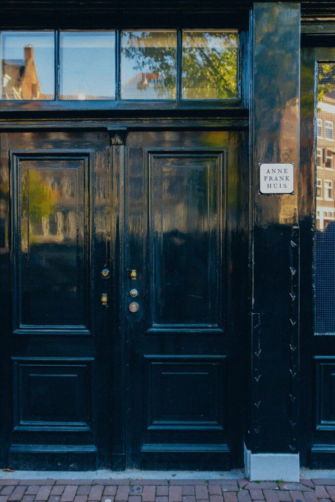 The entrance door to the Anne Frank House in Amsterdam with a commemorative sign