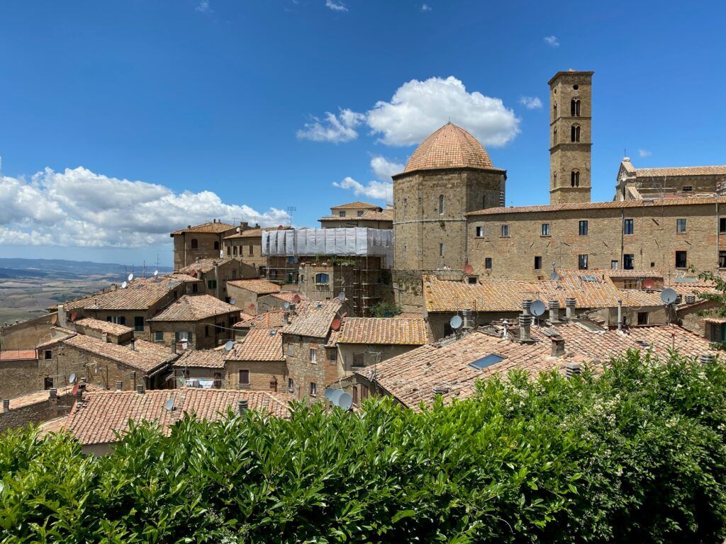 Brown building under blue sky in Tuscany