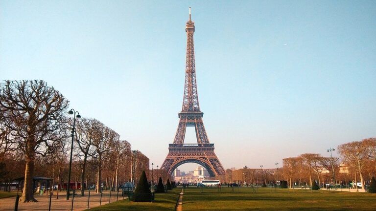 The Eiffel Tower in Paris, France, viewed from the Champ de Mars park on a clear day.