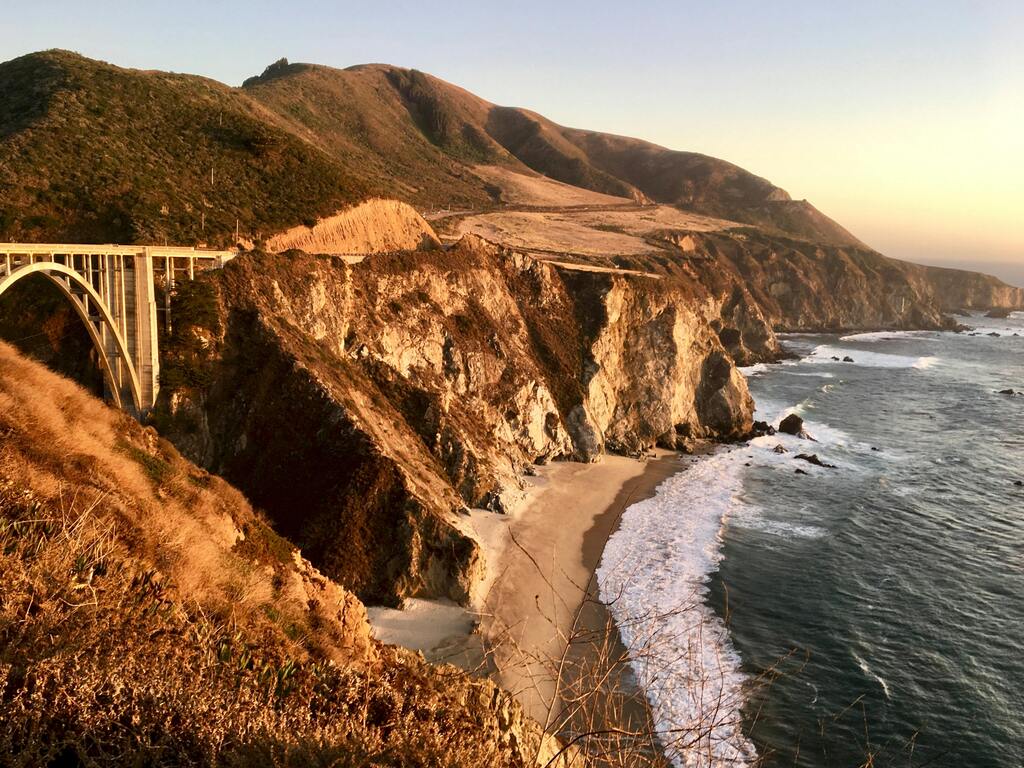 Big Sur, California: Stunning view of the rugged coastline and Bixby Bridge along California’s Pacific Coast Highway at sunset.