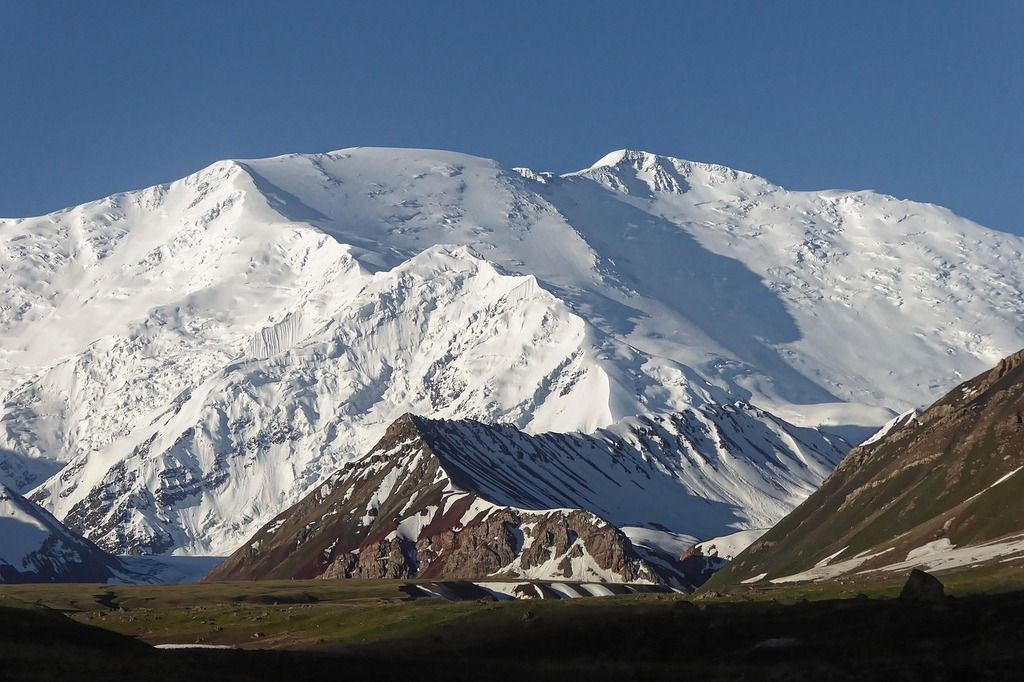 A stunning view of the snow-capped Lenin Peak with its dramatic rugged slopes.