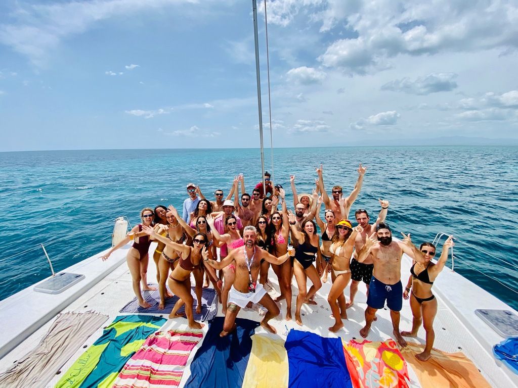 Excited WeRoad group enjoying a catamaran trip on the open sea, during a group tour in Cuba.