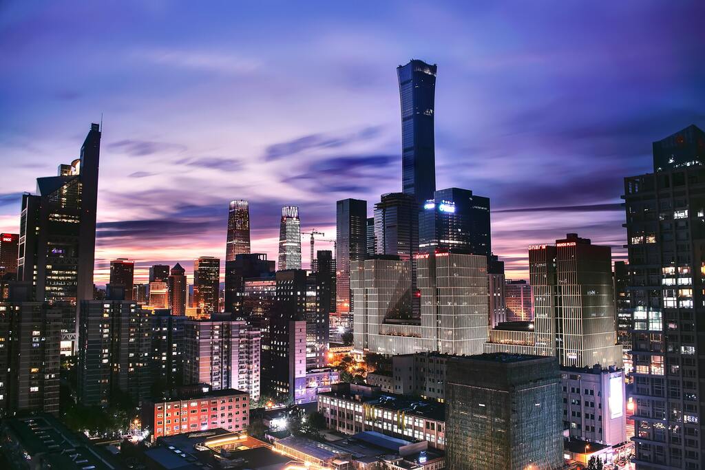 Beijing skyline at sunset, featuring China Zun (CITIC Tower) and modern skyscrapers.