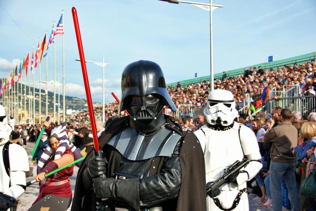 Darth Vader and Stormtroopers marching during a parade.