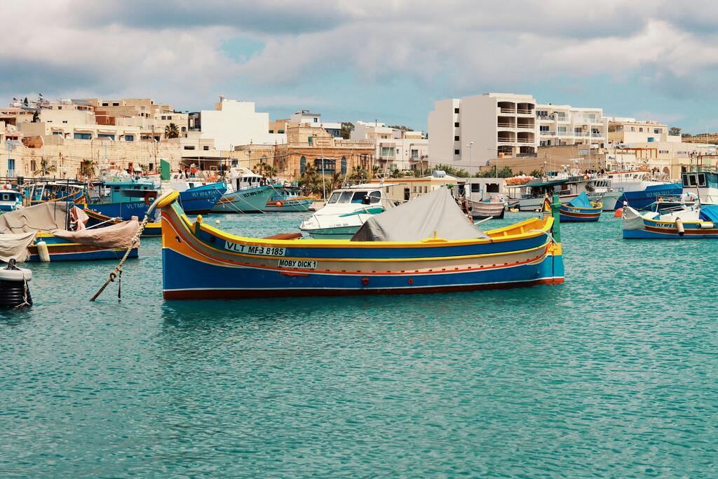 Traditional Maltese boats (luzzus) docked in the port of Marsaxlokk