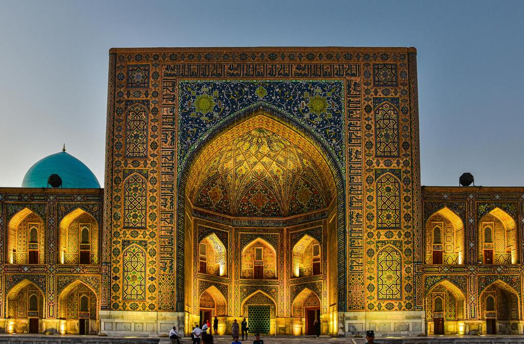 Madrasa at dusk in Samarkand, Uzbekistan, with intricate mosaic decorations