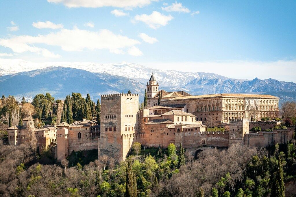 View of the Alhambra in Granada with the Sierra Nevada mountains in the background
