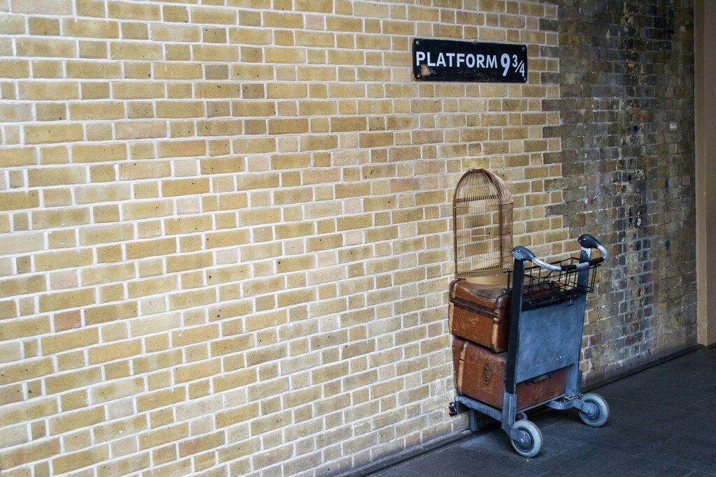 Platform 9 ¾ at King's Cross Station with a trolley going through the wall