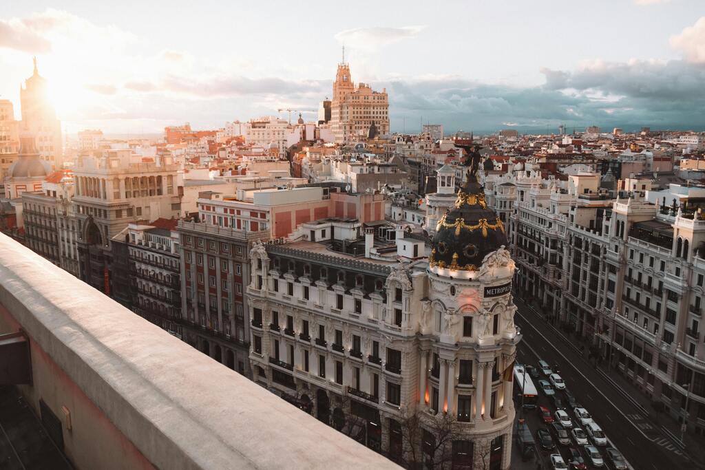 Aerial view of Madrid's Gran Vía and Metropolis building at sunset