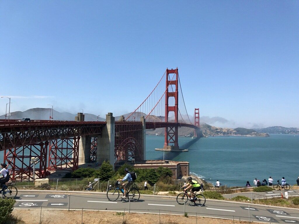 Cyclists riding on a dedicated bike path near the Golden Gate Bridge in San Francisco