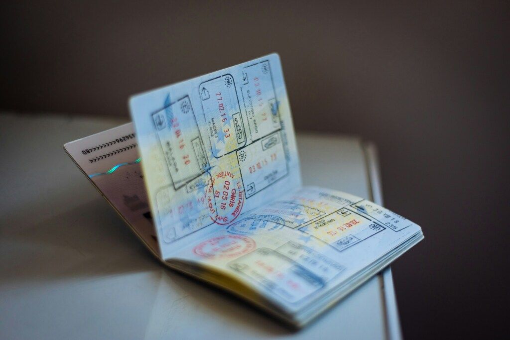 Open passport showing multiple visa stamps and entry/exit markings.