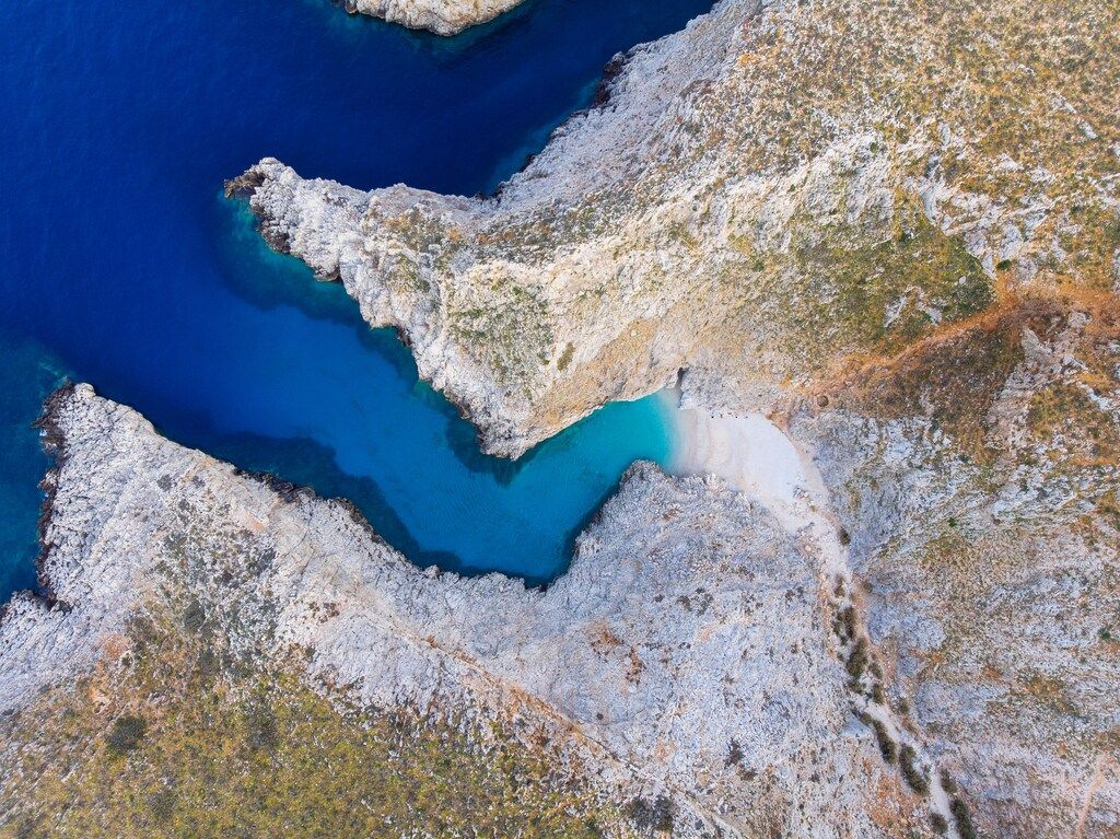 Aerial view of Seitan Limania with turquoise water surrounded by rocky cliffs