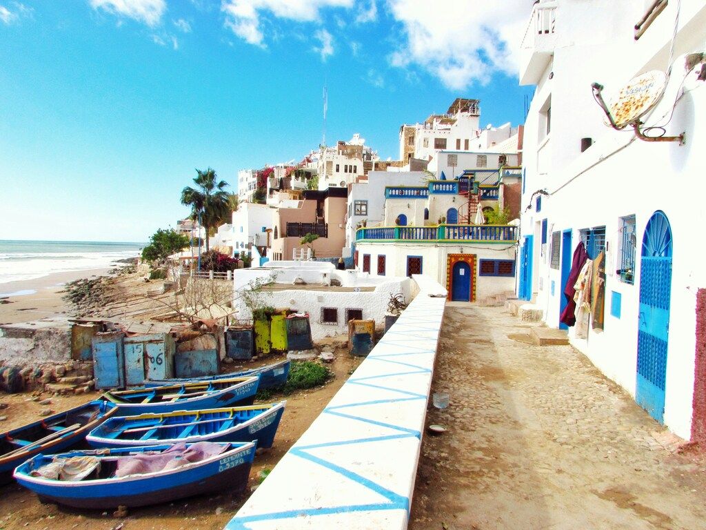 Taghazout with boats and whitewashed houses along the coast in Morocco