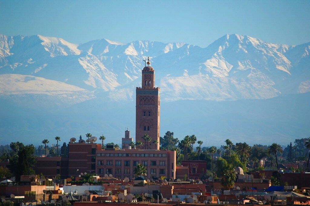 Koutoubia Mosque in Marrakech with the snow-covered Atlas Mountains in the background