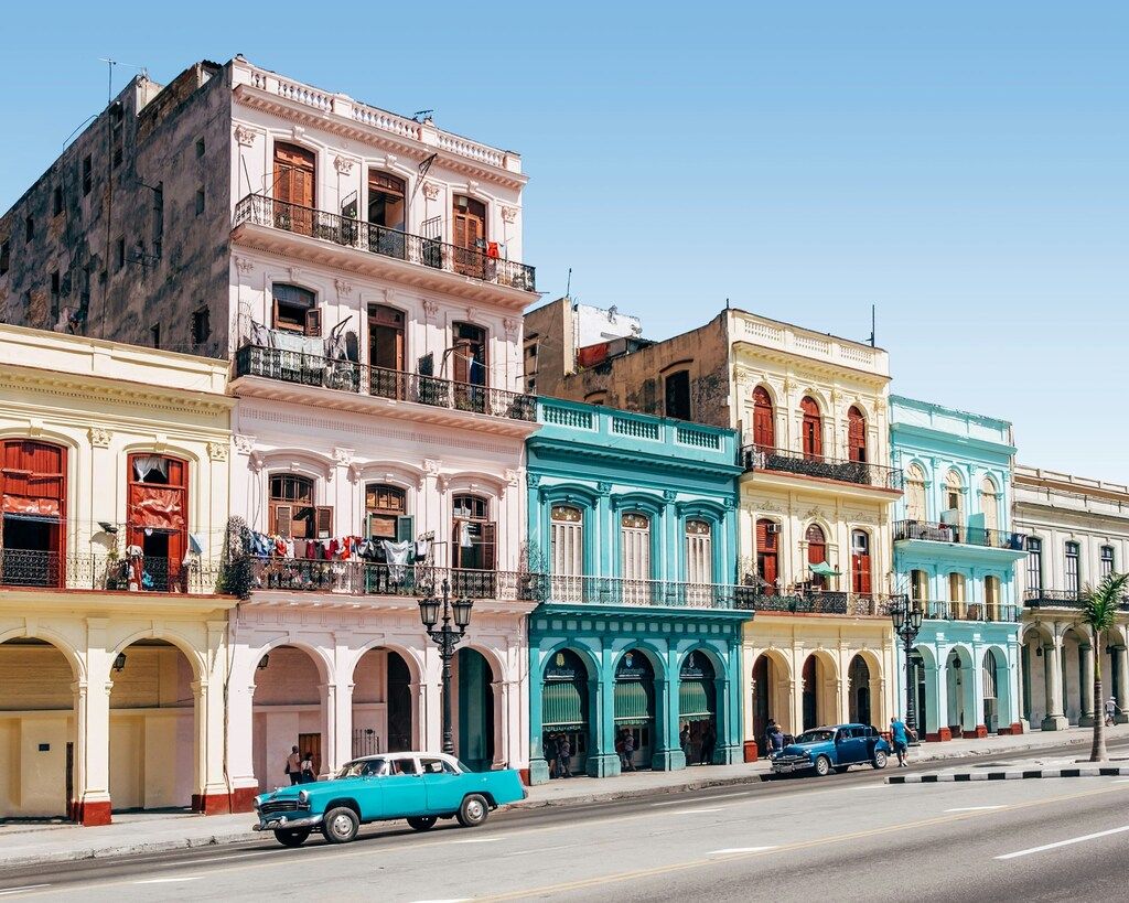  A street in Havana, Cuba, with colorful colonial buildings and vintage cars