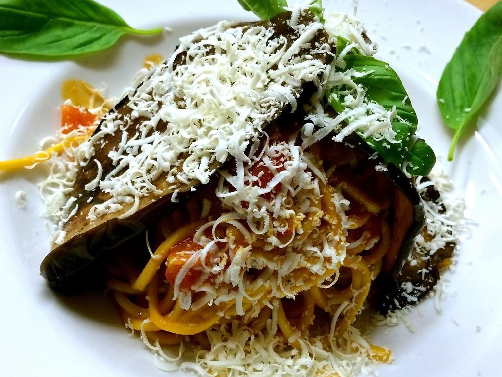 Traditional Sicilian pasta alla norma topped with ricotta salata