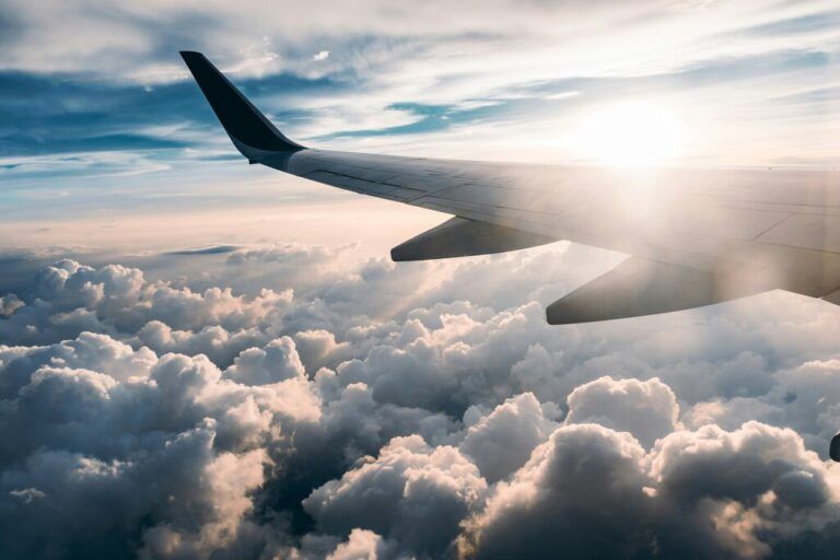 aircraft flying through the clouds - discover how to find cheap last minute flights