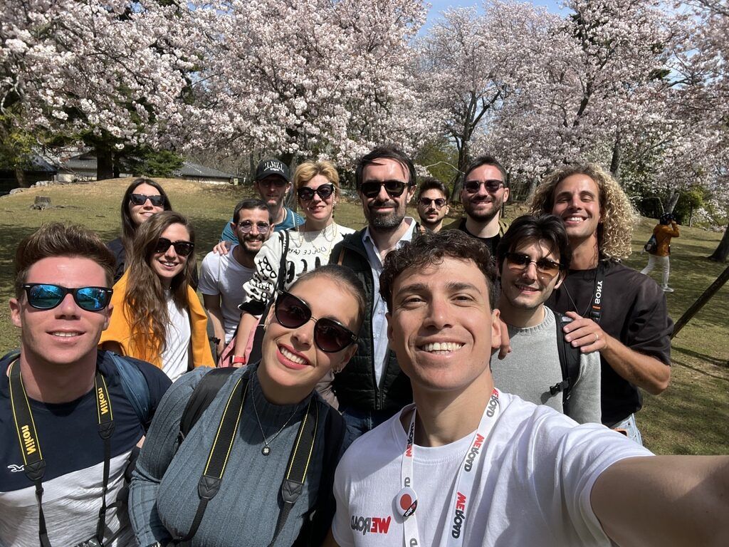 Weroad travelers group selfie under cherry blossom trees in Japan