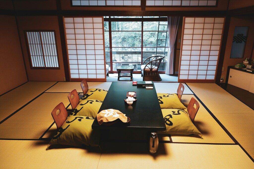 Tatami room in a Japanese ryokan with low table and floor chairs