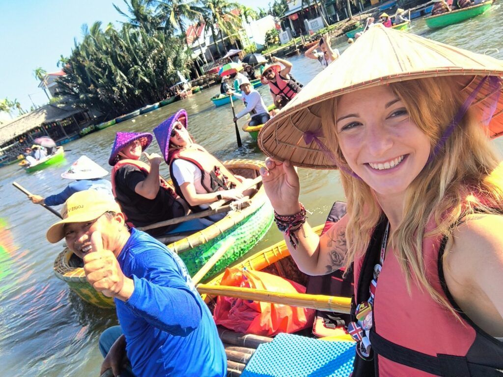 A Weroad tour group is traveling by boat on a river in Vietnam.