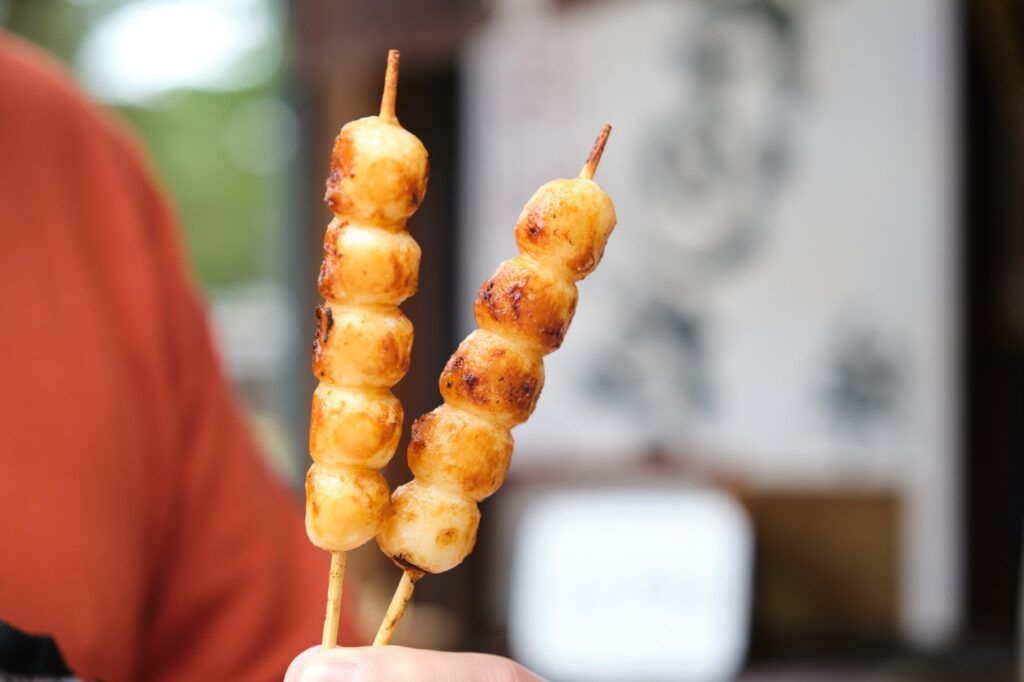Two skewered Dango (rice flour dumplings).