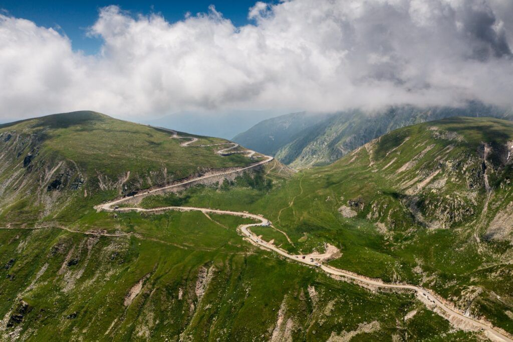 Winding mountain road of the Transfăgărășan Highway cutting through the Carpathians.