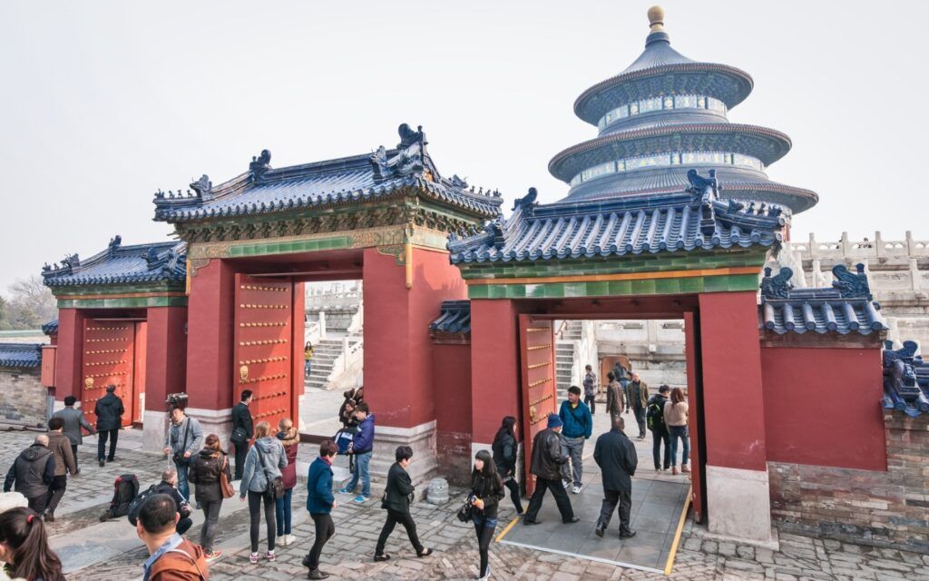 Red walls and a dark-roofed building complex including the Hall of Prayer for Good Harvests tower.