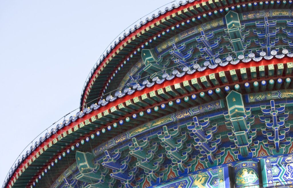 Close-up of the intricately decorated blue, green, and red eaves of the Hall of Prayer for Good Harvests.