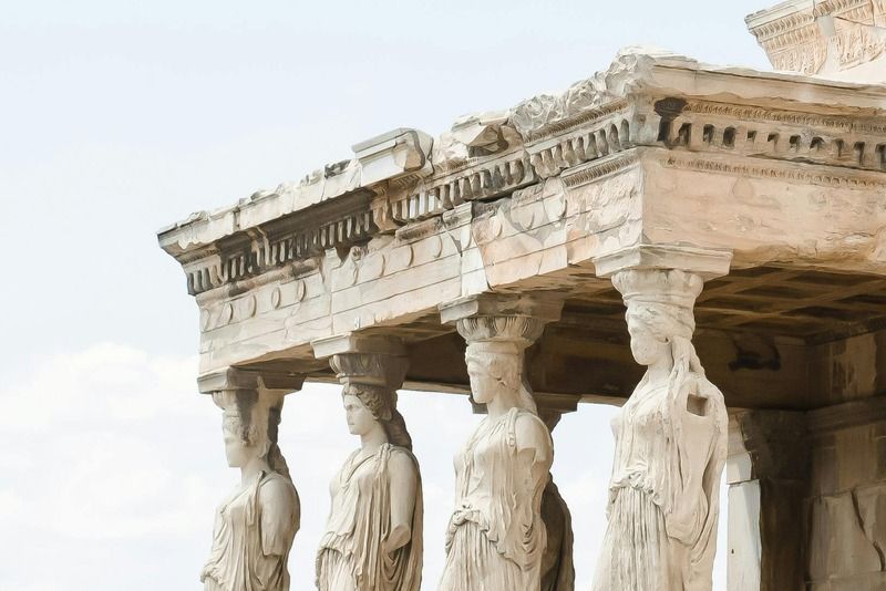 Caryatid Porch of the Erechtheion temple on the Acropolis of Athens, with six marble female statues as columns against a clear sky