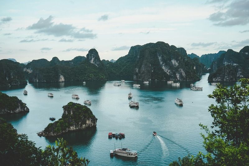 Aerial view of tour boats sailing among limestone karst islands in Halong Bay, Vietnam