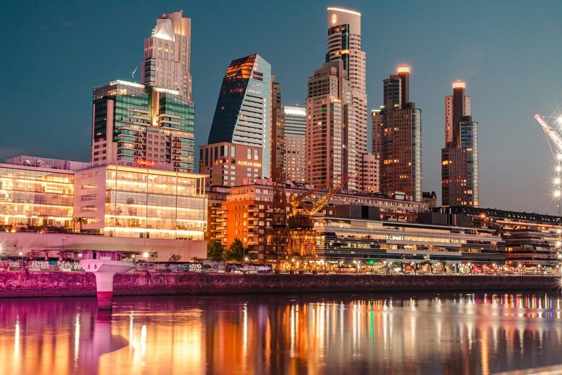 Illuminated skyscrapers of Puerto Madero reflected on the water at night in Buenos Aires